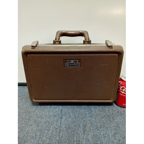 200 - A vintage Buescher wooden clarinet stored in a protective case with a cleaning kit