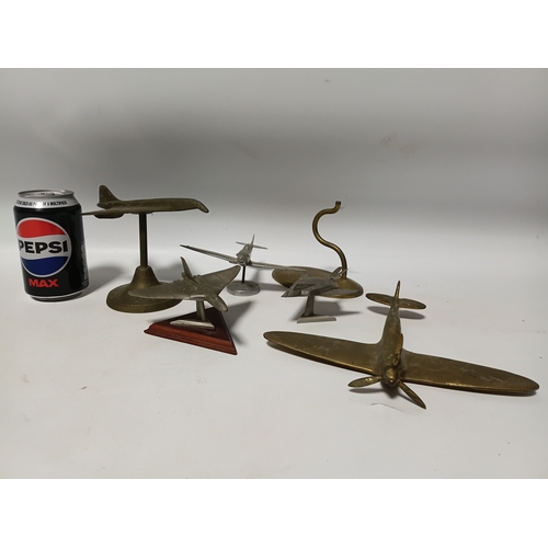214 - A collection of brass and white metal model aeroplanes to include a spitfire, a concorde, a vulcan a... 