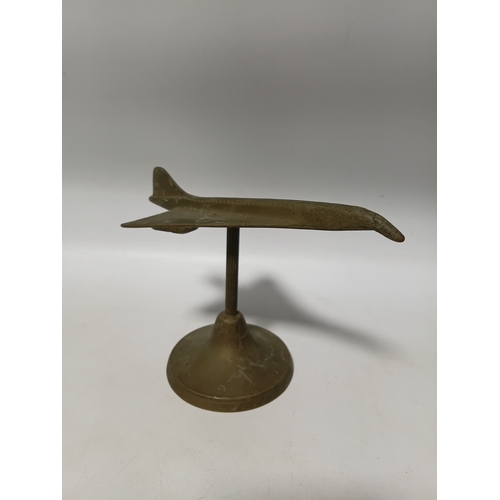 214 - A collection of brass and white metal model aeroplanes to include a spitfire, a concorde, a vulcan a... 