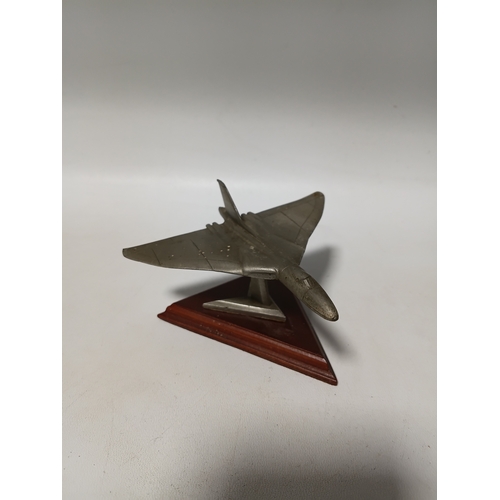 214 - A collection of brass and white metal model aeroplanes to include a spitfire, a concorde, a vulcan a... 