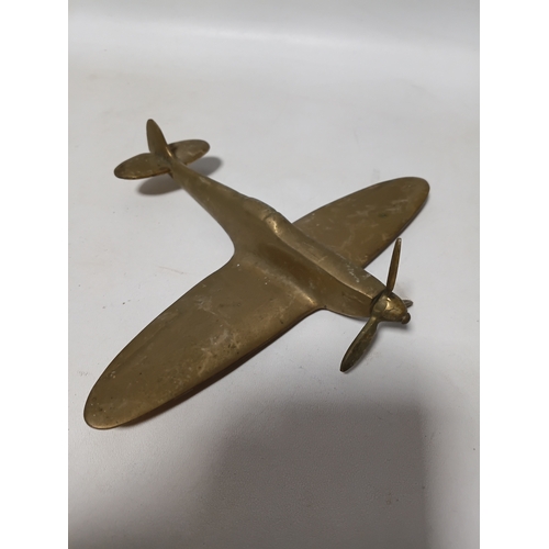 214 - A collection of brass and white metal model aeroplanes to include a spitfire, a concorde, a vulcan a... 
