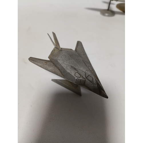 214 - A collection of brass and white metal model aeroplanes to include a spitfire, a concorde, a vulcan a... 
