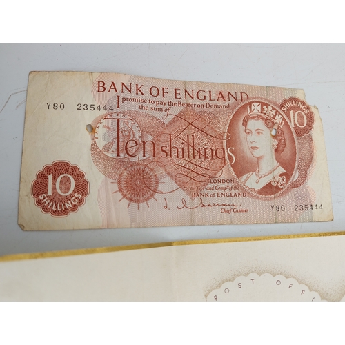 219 - A late 1930s Greetings telegram with 10 shilling note, together with two motor fuel ration books and... 