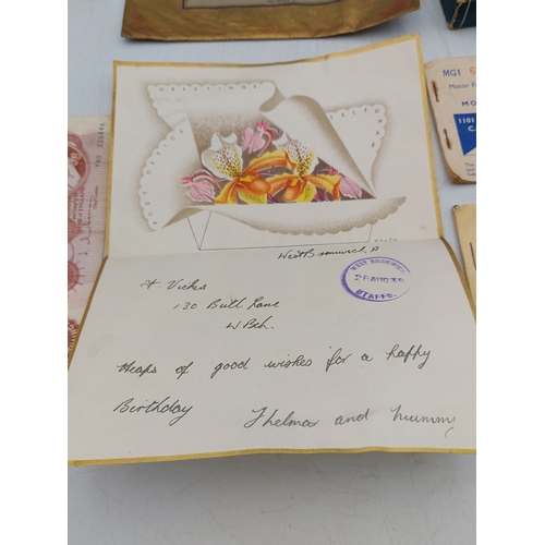 219 - A late 1930s Greetings telegram with 10 shilling note, together with two motor fuel ration books and... 