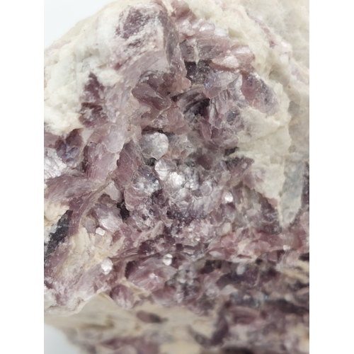 261 - A lepidolite crystal with display case. Measures 4 inches x 2 inches. Weight 515 grams.