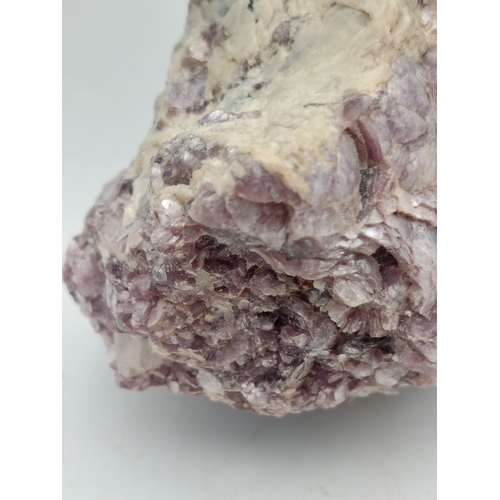 261 - A lepidolite crystal with display case. Measures 4 inches x 2 inches. Weight 515 grams.