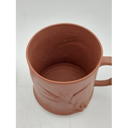 273 - A Chinese Yixing Zisha clay lidded tea mug featuring bamboo-themed decorations.