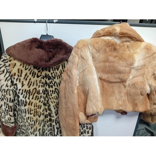 284 - A pair of fur coats - a long leopard print coat with dark brown sleeve cuffs and collar, and a suede... 