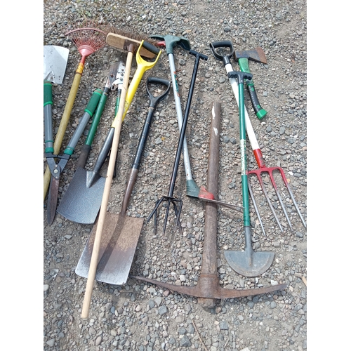 199 - A collection of garden tools. To include shovels, rake, pickaxe, etc...