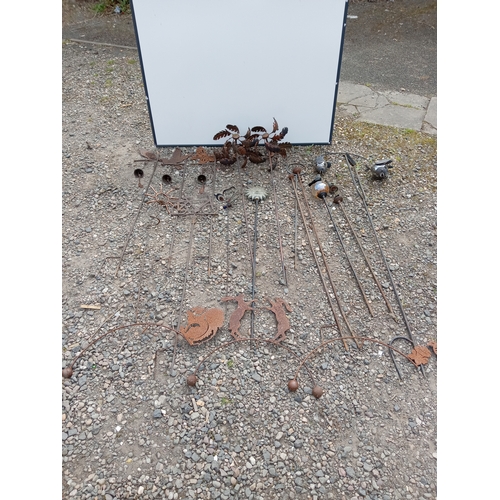 175 - A collection of rustic metal garden decorations.