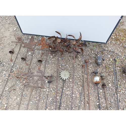 175 - A collection of rustic metal garden decorations.