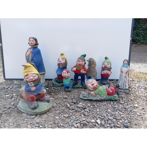 176 - A collection of 9 garden gnomes.