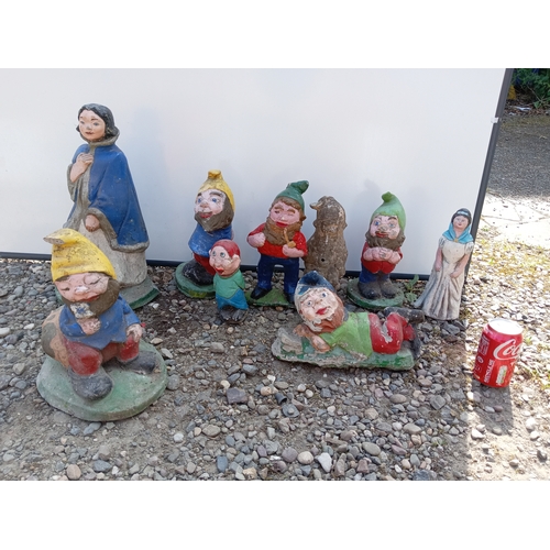 176 - A collection of 9 garden gnomes.