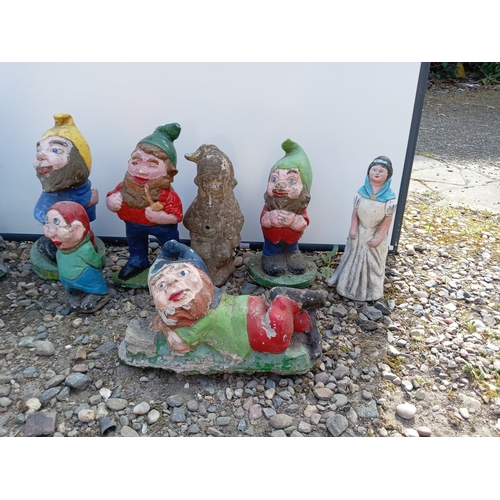 176 - A collection of 9 garden gnomes.
