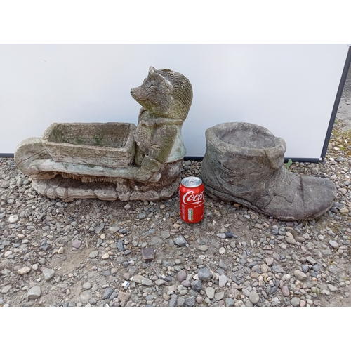 181 - A pair of garden statues. To include boot shaped pot & hedge hog with a wheel barrow planter.