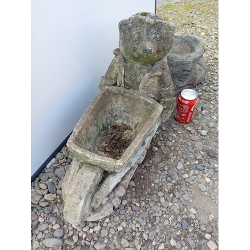 181 - A pair of garden statues. To include boot shaped pot & hedge hog with a wheel barrow planter.