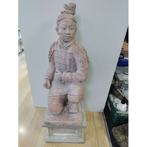 190 - A very large and heavy kneeling terracotta soldier on a plinth. ( Height 102 cm x Width 35 cm x Dept... 