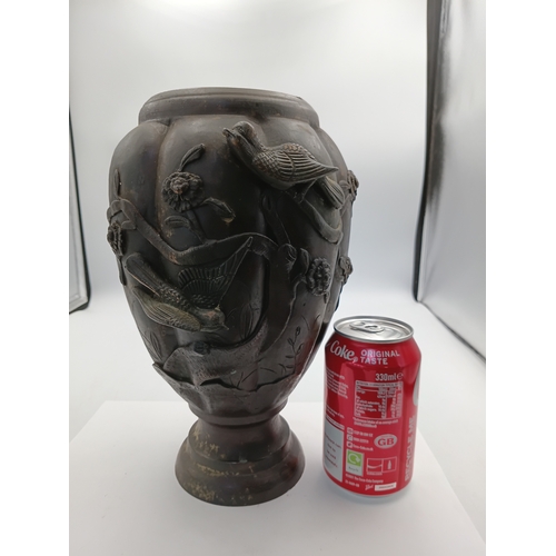 294 - A vintage oriental bronze vase with intricate raised depictions of birds and foliage. Height 10 1/2 ... 