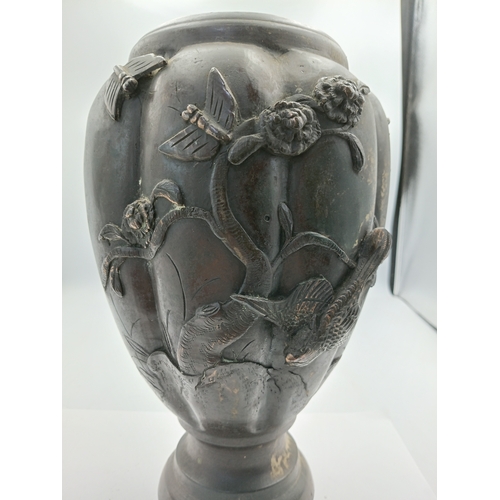 294 - A vintage oriental bronze vase with intricate raised depictions of birds and foliage. Height 10 1/2 ... 