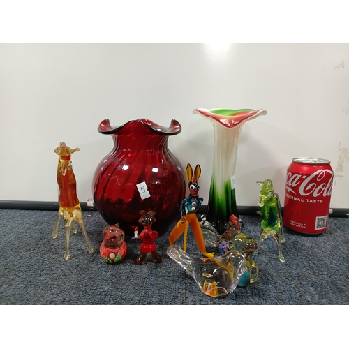 296 - A collection of glass items. To include, a hand blown vase, a Murano style vase and small glass figu... 