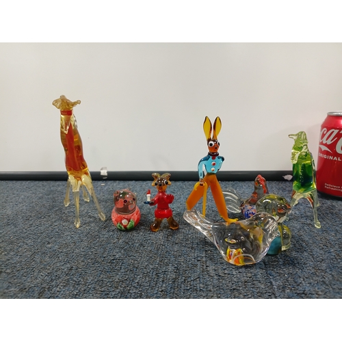 296 - A collection of glass items. To include, a hand blown vase, a Murano style vase and small glass figu... 