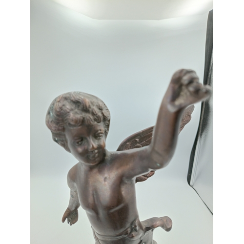 297 - A bronze Cherub statue with wings on a decorative stand. Height 13 inches x Width 6 inches