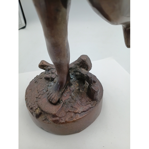 297 - A bronze Cherub statue with wings on a decorative stand. Height 13 inches x Width 6 inches