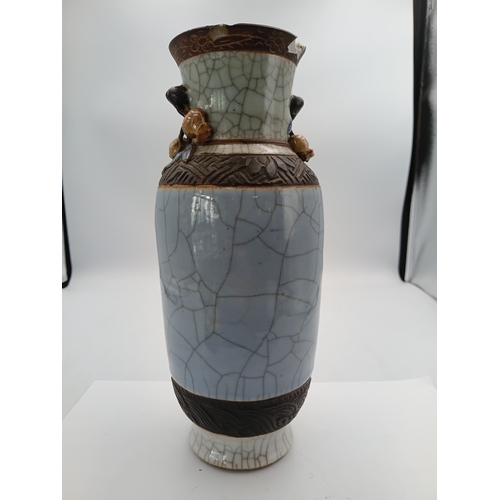 299 - A vintage Chinese crackle glazed vase with a celadon-blue glaze and decorative brown bands. Slight d... 
