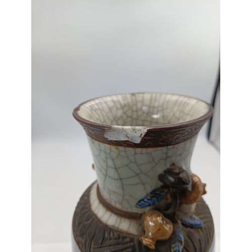299 - A vintage Chinese crackle glazed vase with a celadon-blue glaze and decorative brown bands. Slight d... 