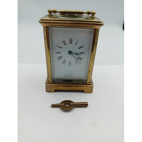 A vintage heavy solid brass carriage clock in working condition & with original key.