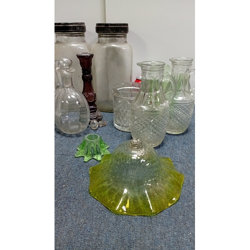 3 - A collection of decorative glass, including stoppered decanters and bottles, covered storage jars, a... 