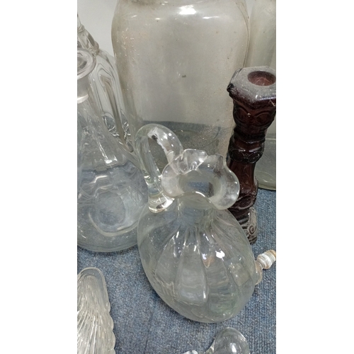 3 - A collection of decorative glass, including stoppered decanters and bottles, covered storage jars, a... 