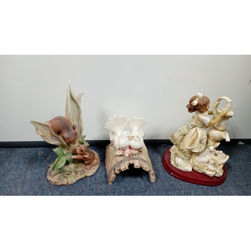 10 - A mixed group of decorative figurines and ornaments, including polychrome bird studies, resin figure... 