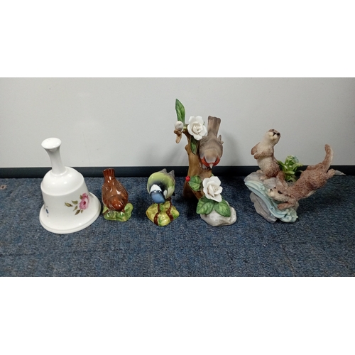 10 - A mixed group of decorative figurines and ornaments, including polychrome bird studies, resin figure... 