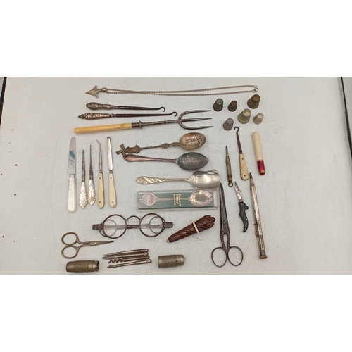 12 - A quantity of assorted small metalwares including sewing thimbles, silverplate souvenir spoons, moth... 