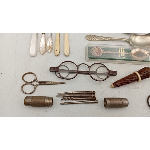 12 - A quantity of assorted small metalwares including sewing thimbles, silverplate souvenir spoons, moth... 