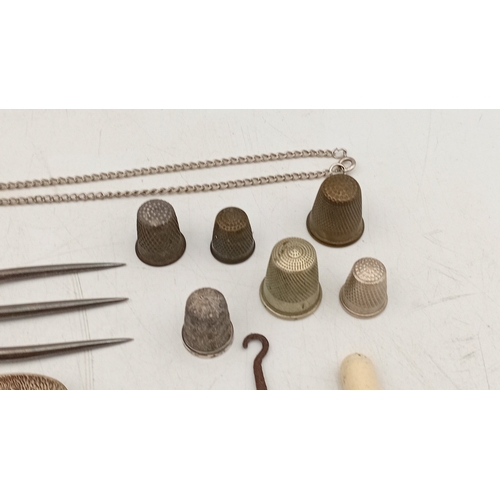12 - A quantity of assorted small metalwares including sewing thimbles, silverplate souvenir spoons, moth... 