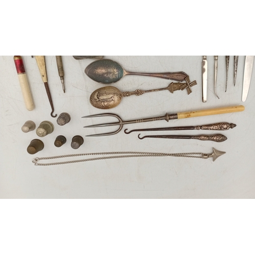 12 - A quantity of assorted small metalwares including sewing thimbles, silverplate souvenir spoons, moth... 