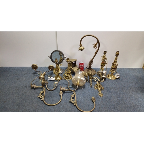13 - A group of brass and gilt-metal lighting fittings comprising table lamps, wall sconces and ceiling c... 