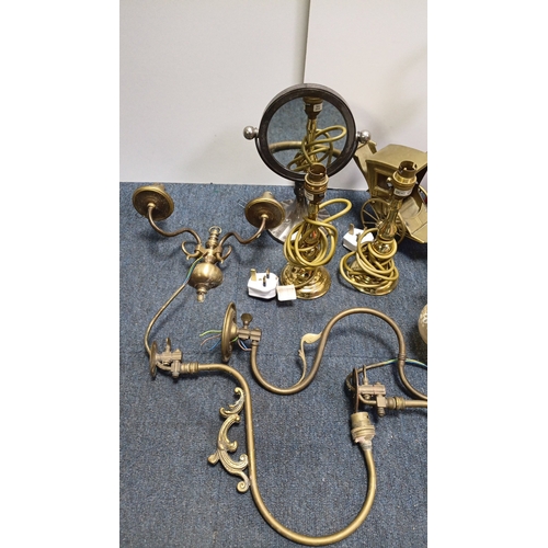 13 - A group of brass and gilt-metal lighting fittings comprising table lamps, wall sconces and ceiling c... 