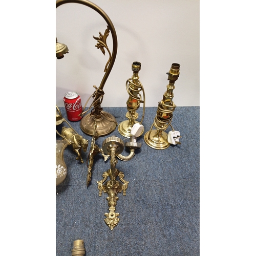 13 - A group of brass and gilt-metal lighting fittings comprising table lamps, wall sconces and ceiling c... 