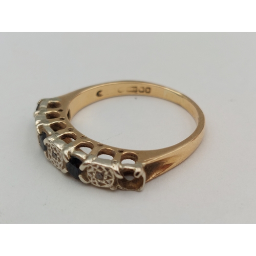 393 - A hallmarked 375 9ct gold ring set with diamonds and sapphires. One missing. Size P