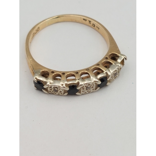 393 - A hallmarked 375 9ct gold ring set with diamonds and sapphires. One missing. Size P