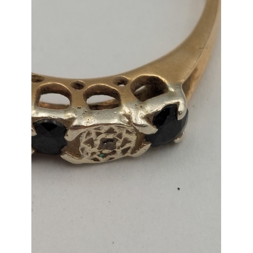 393 - A hallmarked 375 9ct gold ring set with diamonds and sapphires. One missing. Size P