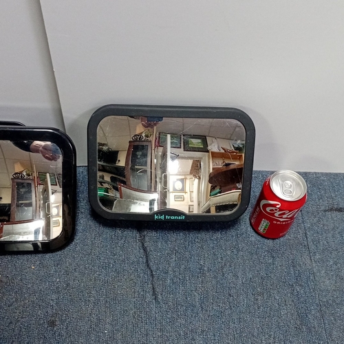 16 - A pair of moulded plastic in-car safety mirrors, Monojoy and Kid Transit, each with adjustable webbi... 