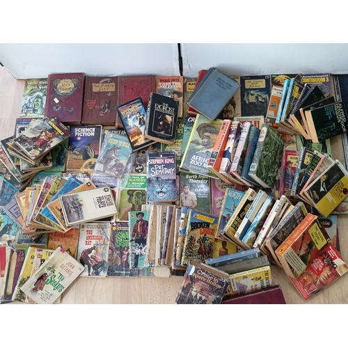 19 - A quantity of 20th-century paperback and hardback books, largely popular fiction and genre titles, i... 