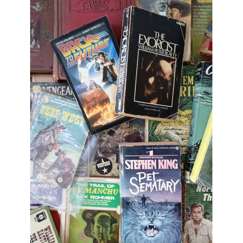 19 - A quantity of 20th-century paperback and hardback books, largely popular fiction and genre titles, i... 