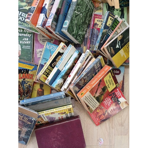 19 - A quantity of 20th-century paperback and hardback books, largely popular fiction and genre titles, i... 