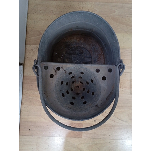 20 - A group of two garden watering vessels: a black-painted metal watering can with domed cover and hand... 