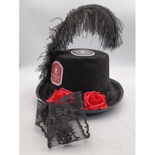 21 - Steampunk-inspired black felt top hat, embellished with feather plume, faux goggles, applied gear mo... 